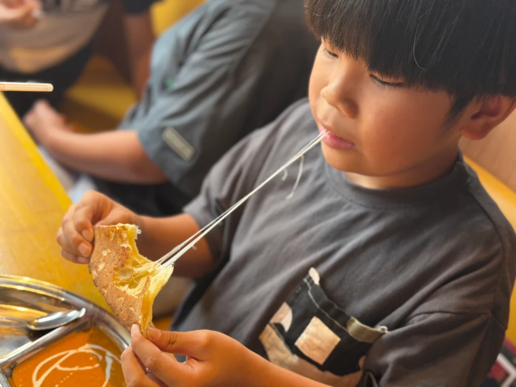 インドカレー店MINAで大きなナンとカレーを楽しむにこにこスイッチの子どもたち
